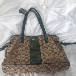 Coach Bag Monogram green and tan. 2 zippered pockets & 2 open pockets inside.